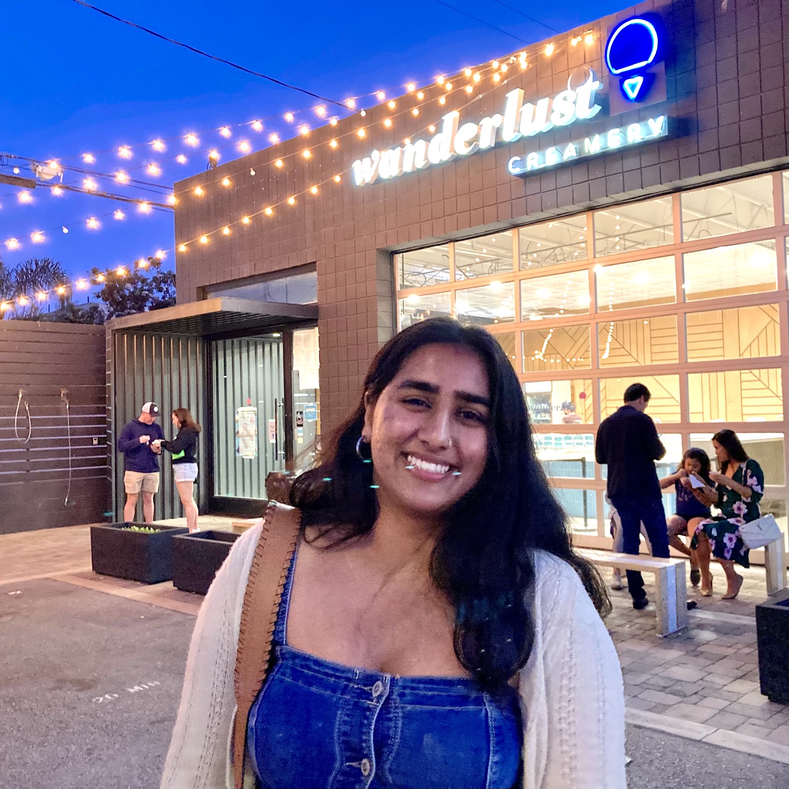 Vidisha standing in front of ice cream shop.